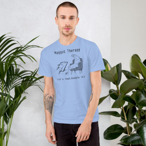 A man wearing a baby blue t-shirt with a drawing of a large maggot in a therapy session with the words Maggot Therapy (it's real, Google it). Designed by Kenny Velez.