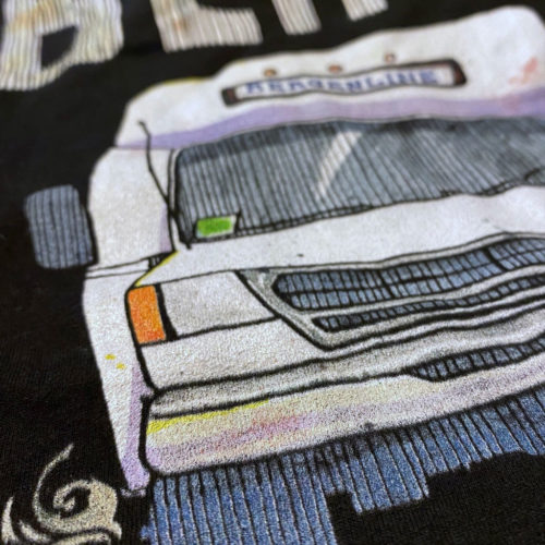 A closeup of a black t-shirt with a drawing of a Bergenline jitney dollar bus from Union City, NJ with word BLine on top. Designed by Kenny Velez