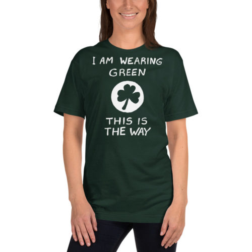 A woman wearing a A green tshirt saying I AM WEARING GREEN. THIS IS THE WAY. with a shamrock in the middle