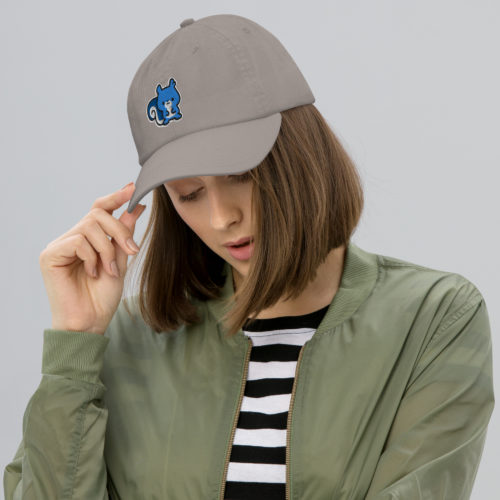 a woman wearing a Grey Champion brand baseball hat with a cute blue embroidered squirrel