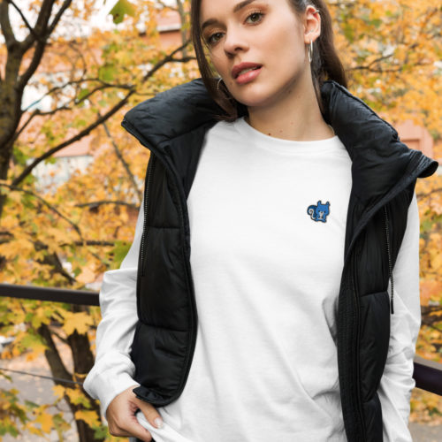 A woman wearing a white long sleeve shirt with a cute blue squirrel embroidery