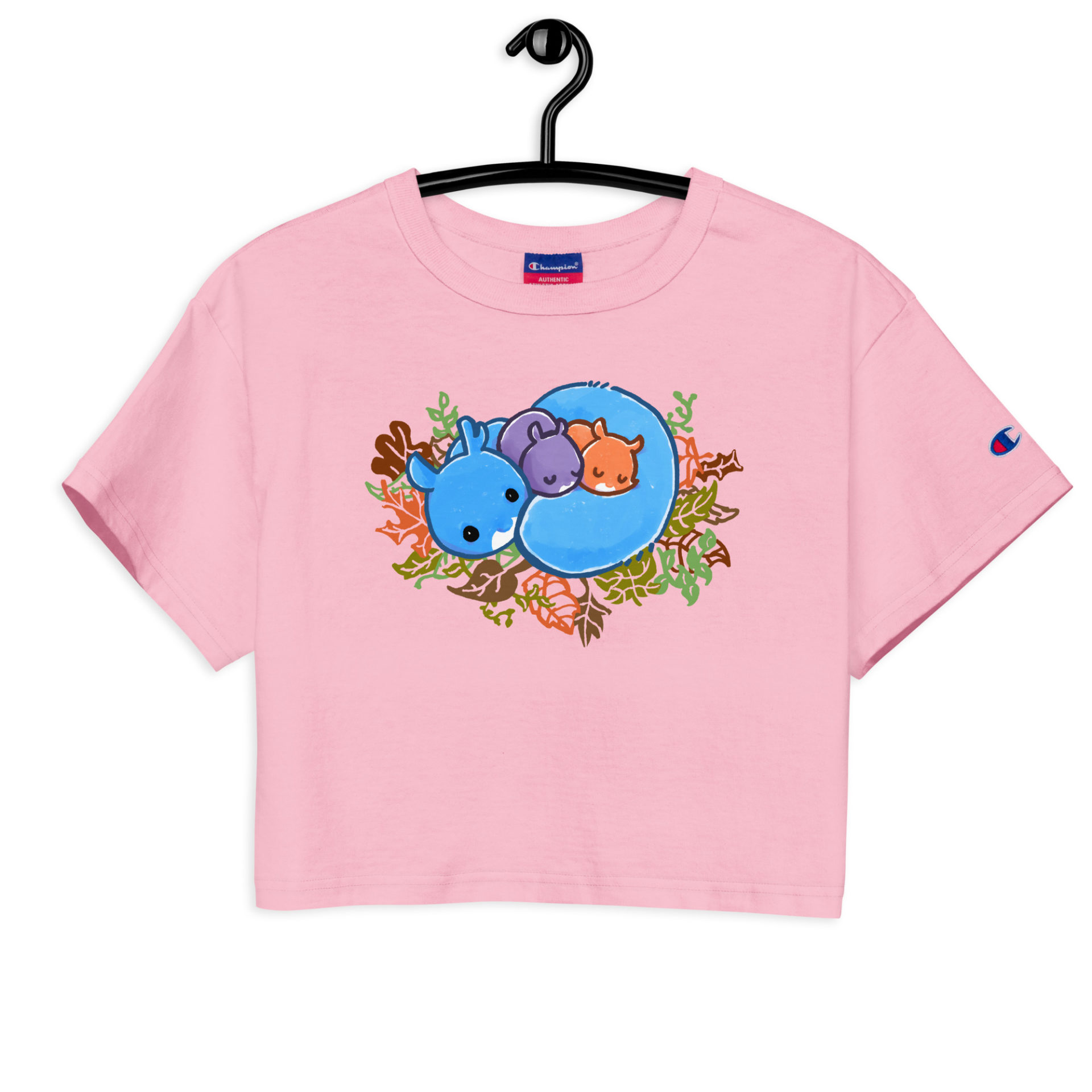 a pink crop top shirt with a cute Ma Squirrel sleeping in her nest with 2 kids on a hanger