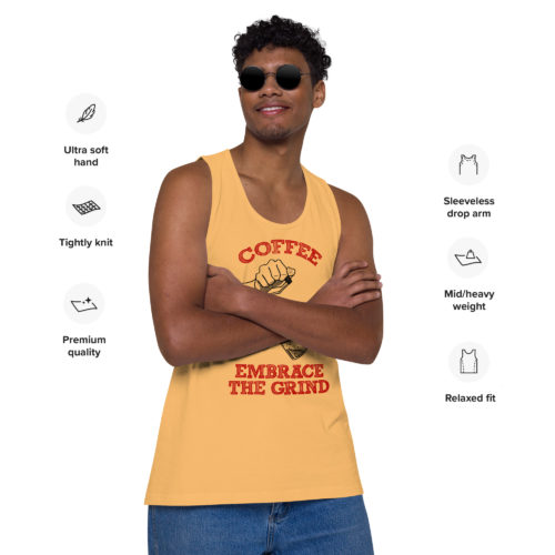 A guy wearing a yellow tank top with a drawing of hands using a handheld coffee grinder with the words COFFEE EMBRACE THE GRIND. Designed by Kenny Velez