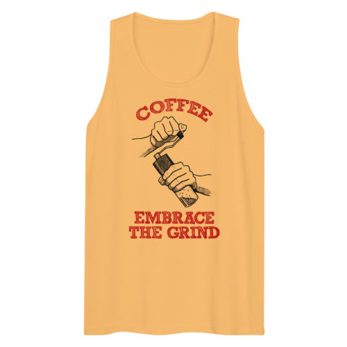 A yellow tank top with a drawing of hands using a handheld coffee grinder with the words COFFEE EMBRACE THE GRIND. Designed by Kenny Velez