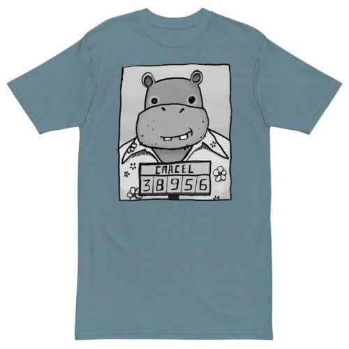 a blue green t-shirt with a drawing of a mugshot featuring a cartoon hippo in a Hawaiian shirt in the vein of the iconic mugshot of Pablo Escobar. Designed by Kenny Velez.