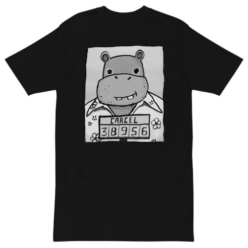 A black t-shirt with a drawing of a mugshot featuring a cartoon hippo in a Hawaiian shirt in the vein of the iconic mugshot of Pablo Escobar. Designed by Kenny Velez.