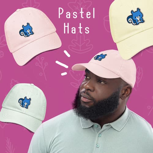 A man wearing a pink pastel baseball hat with a cute blue squirrel embroidery. Ma Squirrel by Kenny Velez is the brand.