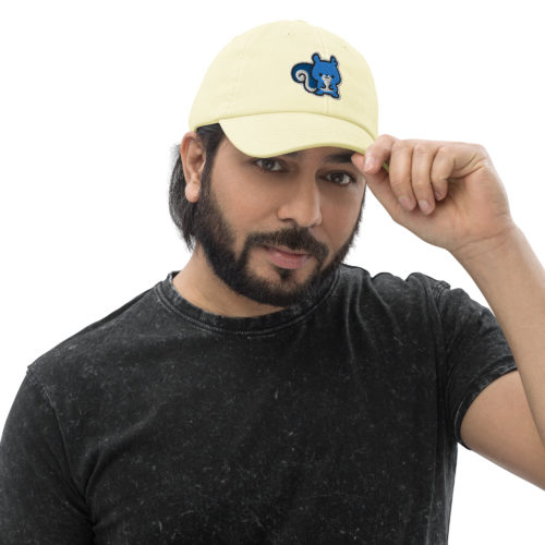 Man wearing a lemon yellow pastel baseball hat with a cute blue embroidered squirrel