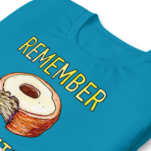 a blue t-shirt with a drawing of a bitten cronut with the words REMEMBER CRONUTS? in yellow lettering. Designed by Kenny Velez.