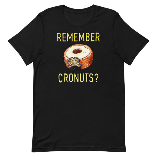 a black t-shirt with a drawing of a bitten cronut with the words REMEMBER CRONUTS? in yellow lettering. Designed by Kenny Velez.