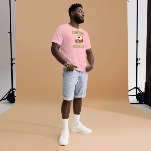 A man wearing a pink t-shirt with a drawing of a bitten cronut with the words REMEMBER CRONUTS? in yellow lettering. Designed by Kenny Velez.