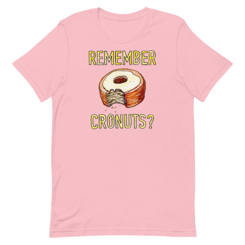 a pink t-shirt with a drawing of a bitten cronut with the words REMEMBER CRONUTS? in yellow lettering. Designed by Kenny Velez.