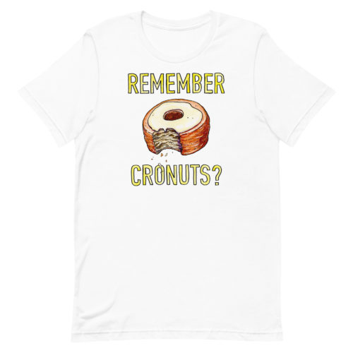 a white t-shirt with a drawing of a bitten cronut with the words REMEMBER CRONUTS? in yellow lettering. Designed by Kenny Velez.