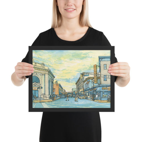 a woman holding a framed poster of a watercolor painting of Union City, NJ at Bergenline and 32nd St.