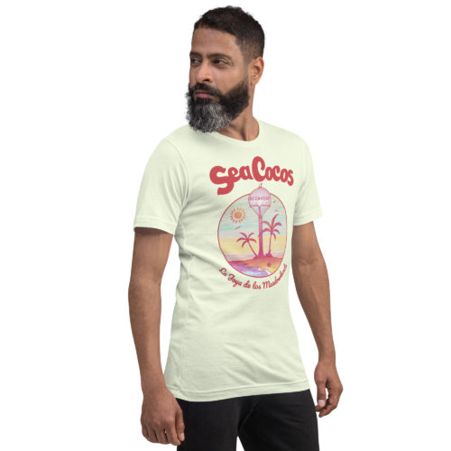 a guy wearing a citron color t-shirt with a drawing of the water tower from Secaucus, NJ on a beach, with the words Sea Cocos, La Joya de los Meadowlands. Designed by Kenny Velez.