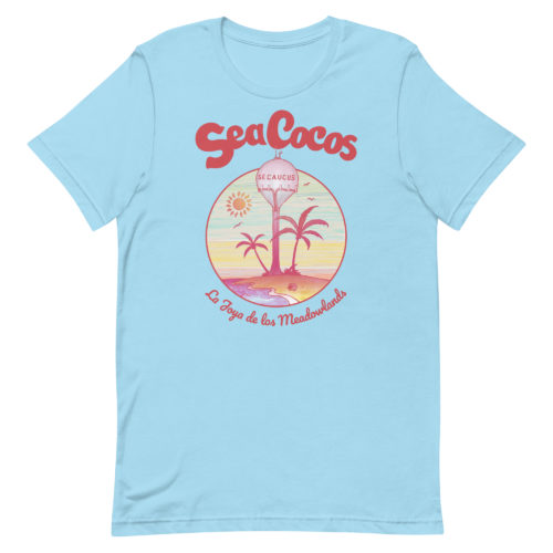 blue t-shirt with a drawing of the water tower from Secaucus, NJ on a beach, with the words Sea Cocos, La Joya de los Meadowlands. Designed by Kenny Velez.