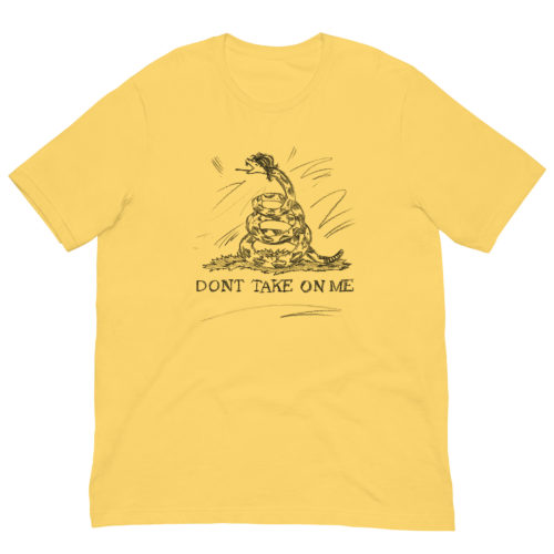 a yellow t-shirt with a drawing of a modified Gadsden flag but drawn in pencil with the words Don't Take on Me. A play on the a-ha - Take On Me Music Video. The snake has a mullet.