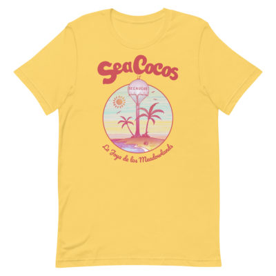 yellow color t-shirt with a drawing of the water tower from Secaucus, NJ on a beach, with the words Sea Cocos, La Joya de los Meadowlands. Designed by Kenny Velez.